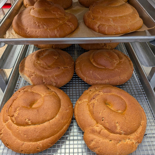 Several golden round loaves of spiraled egg-free challah bread